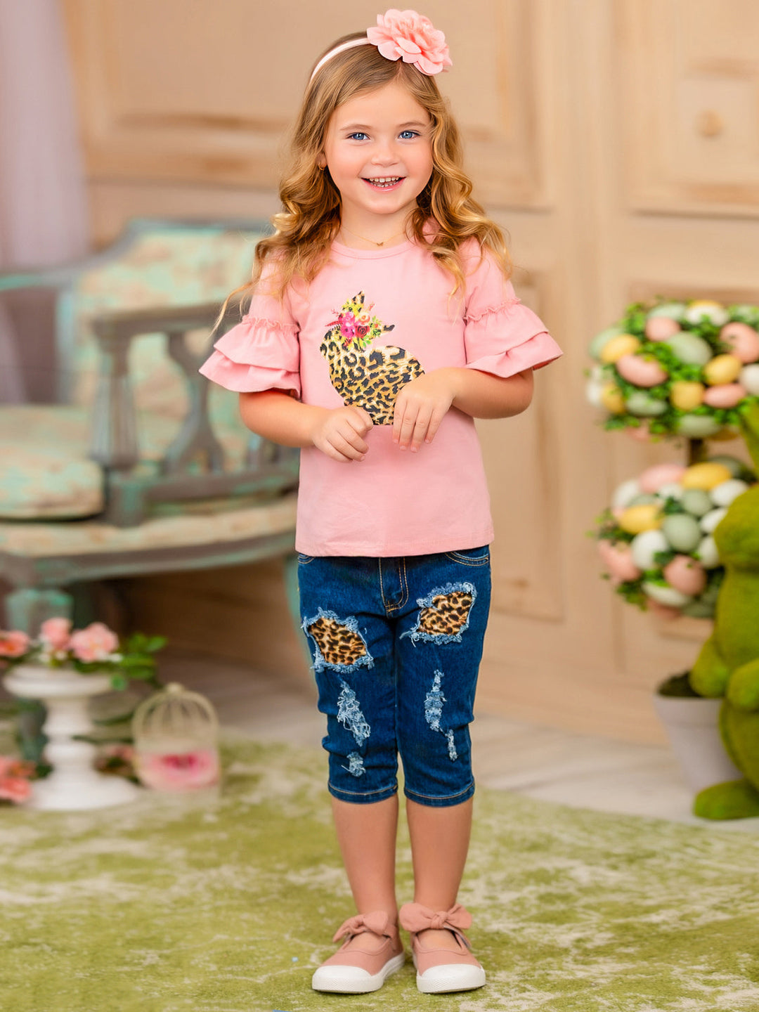 Girls Easter-themed set features a ruffled sleeve top with a leopard print bunny graphic and patched denim capris with a leopard print sash belt for 2T to 10Y toddlers and girls