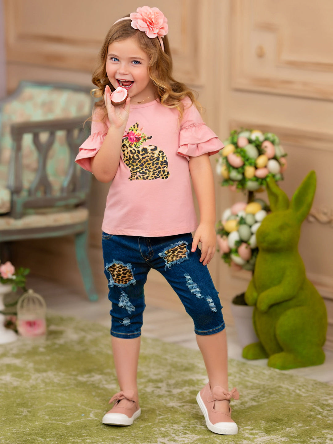 Girls Easter-themed set features a ruffled sleeve top with a leopard print bunny graphic and patched denim capris with a leopard print sash belt for 2T to 10Y toddlers and girls