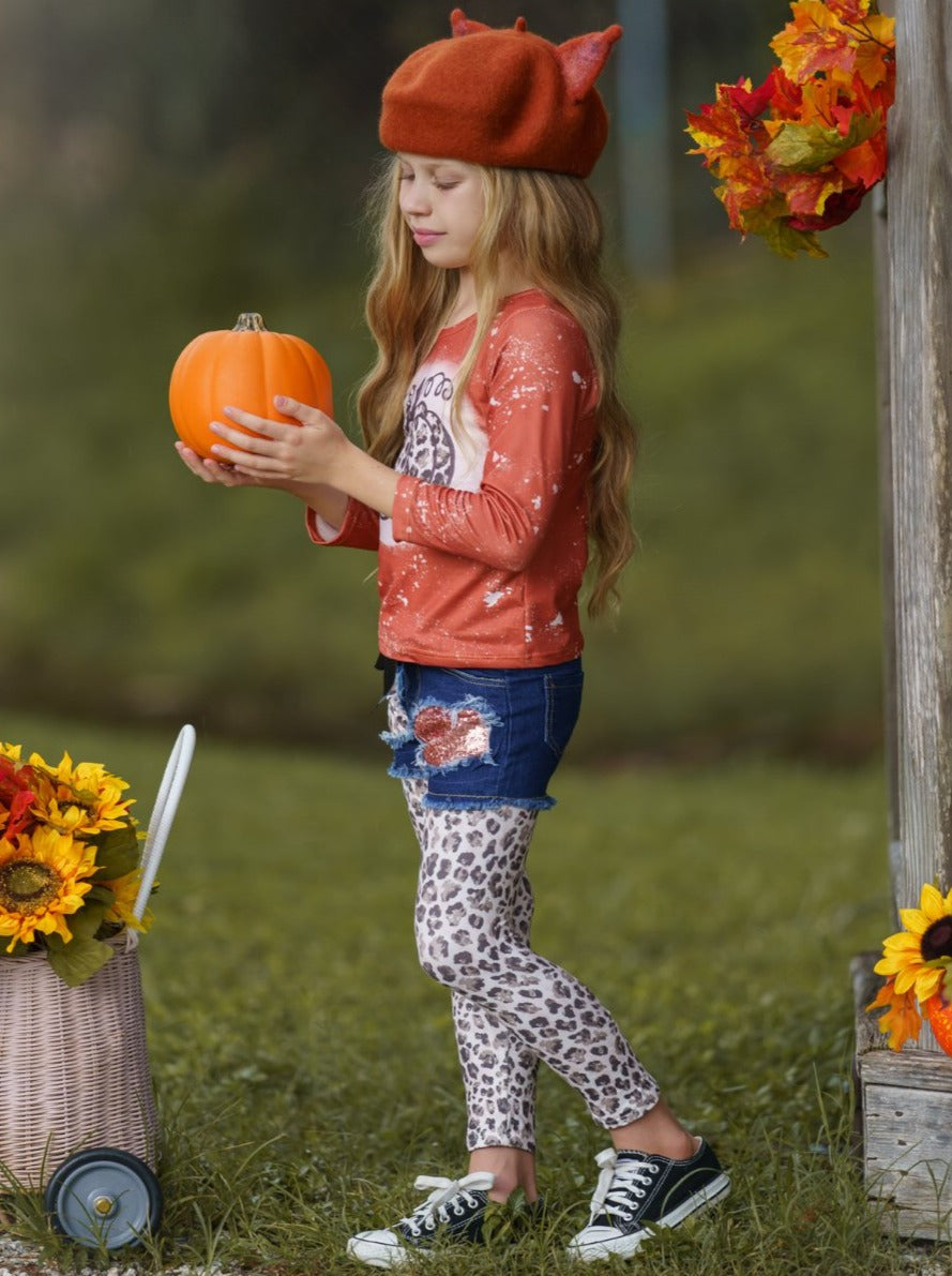 Girls Set features a top with leopard pumpkin print and patched denim shorts with black sash and leopard leggings