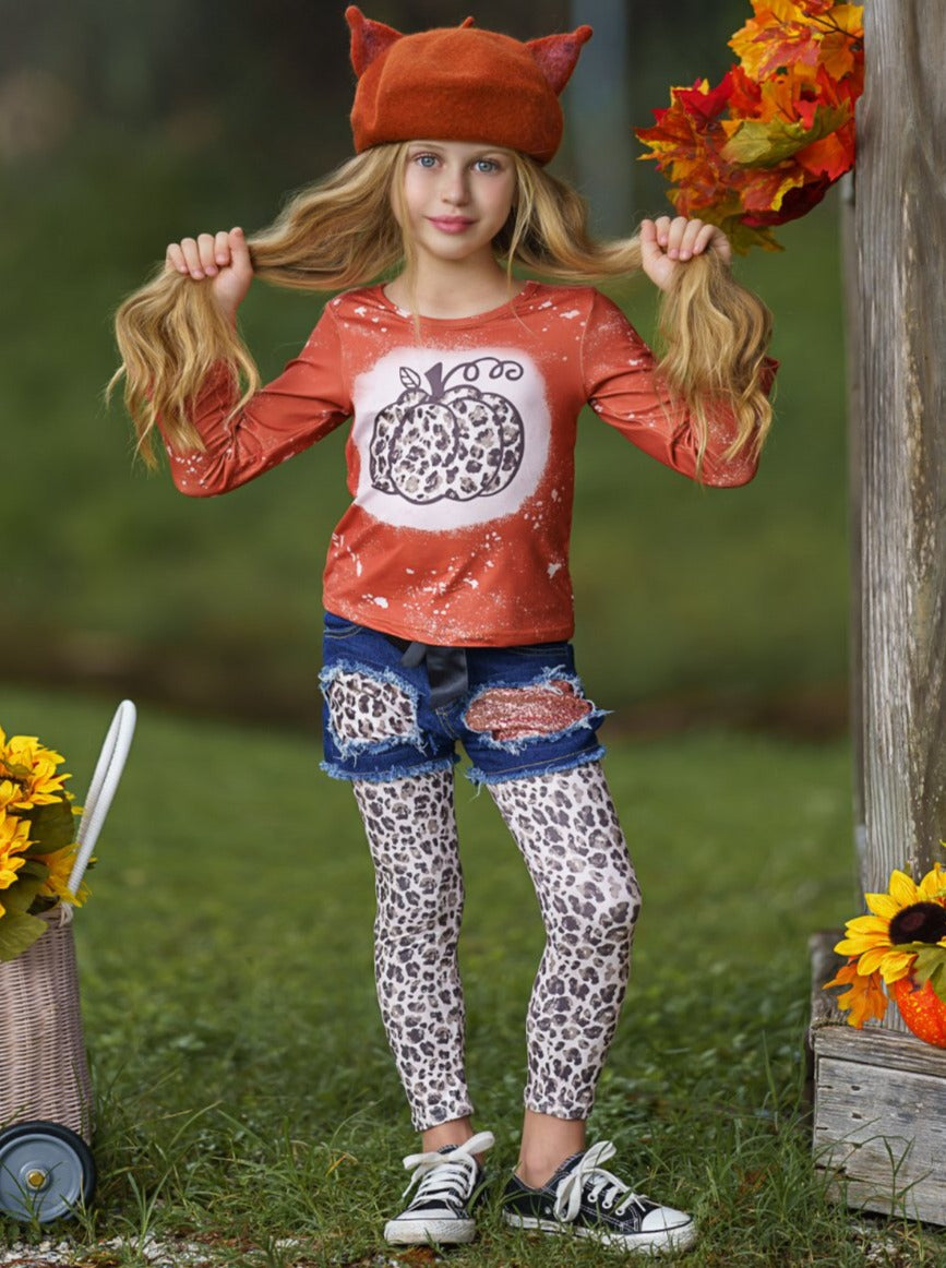 Girls Set features a top with leopard pumpkin print and patched denim shorts with black sash and leopard leggings