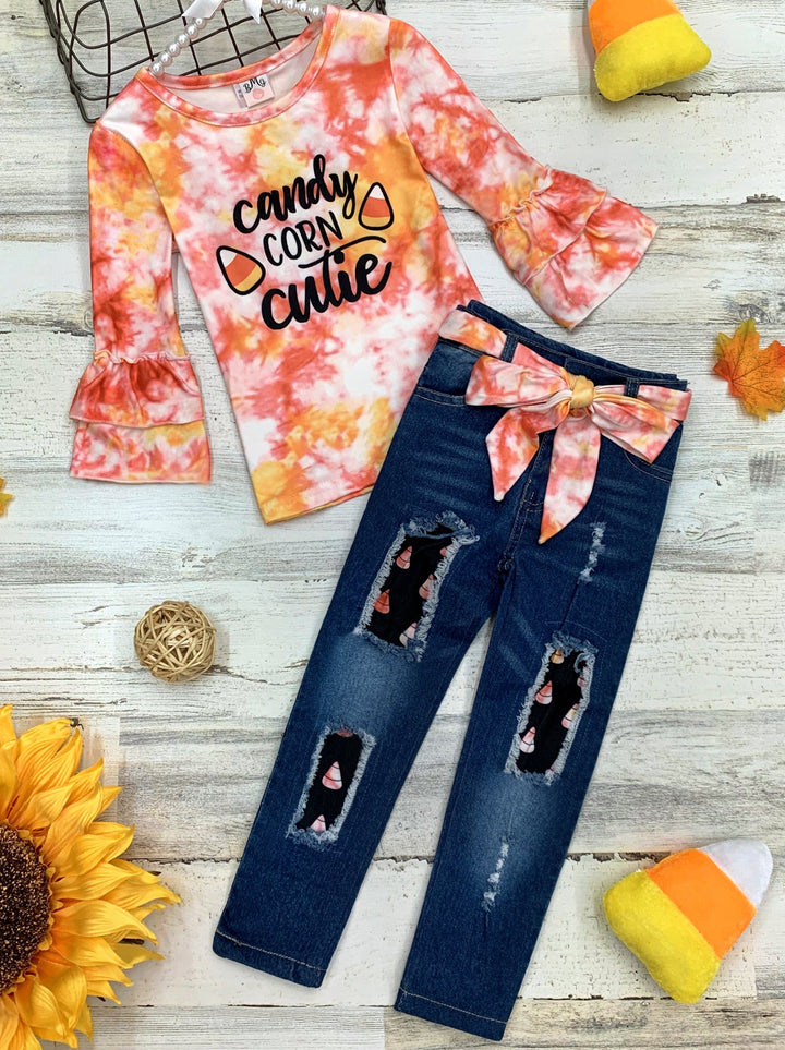 Little girls long-sleeve tie-dye top with double ruffle cuffs, "Candy Corn Cutie" graphic print, fabric-patched jeans, and a matching tie-dye sash belt - Mia Belle Girls