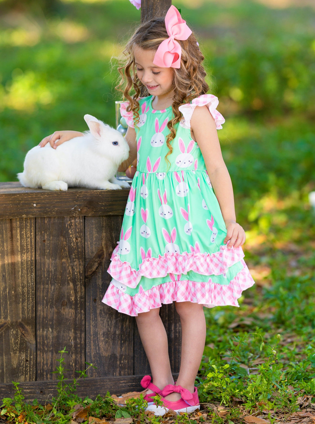 Girls Easter dress features a bunny print two-tiered design with Gingham flutter sleeves and hem