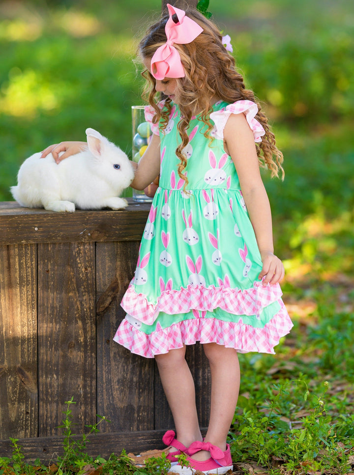 Girls Easter dress features a bunny print two-tiered design with Gingham flutter sleeves and hem