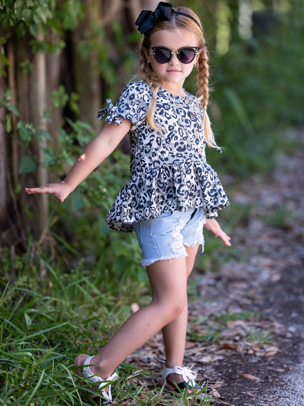 girls set features a leopard printed top with distressed denim shorts