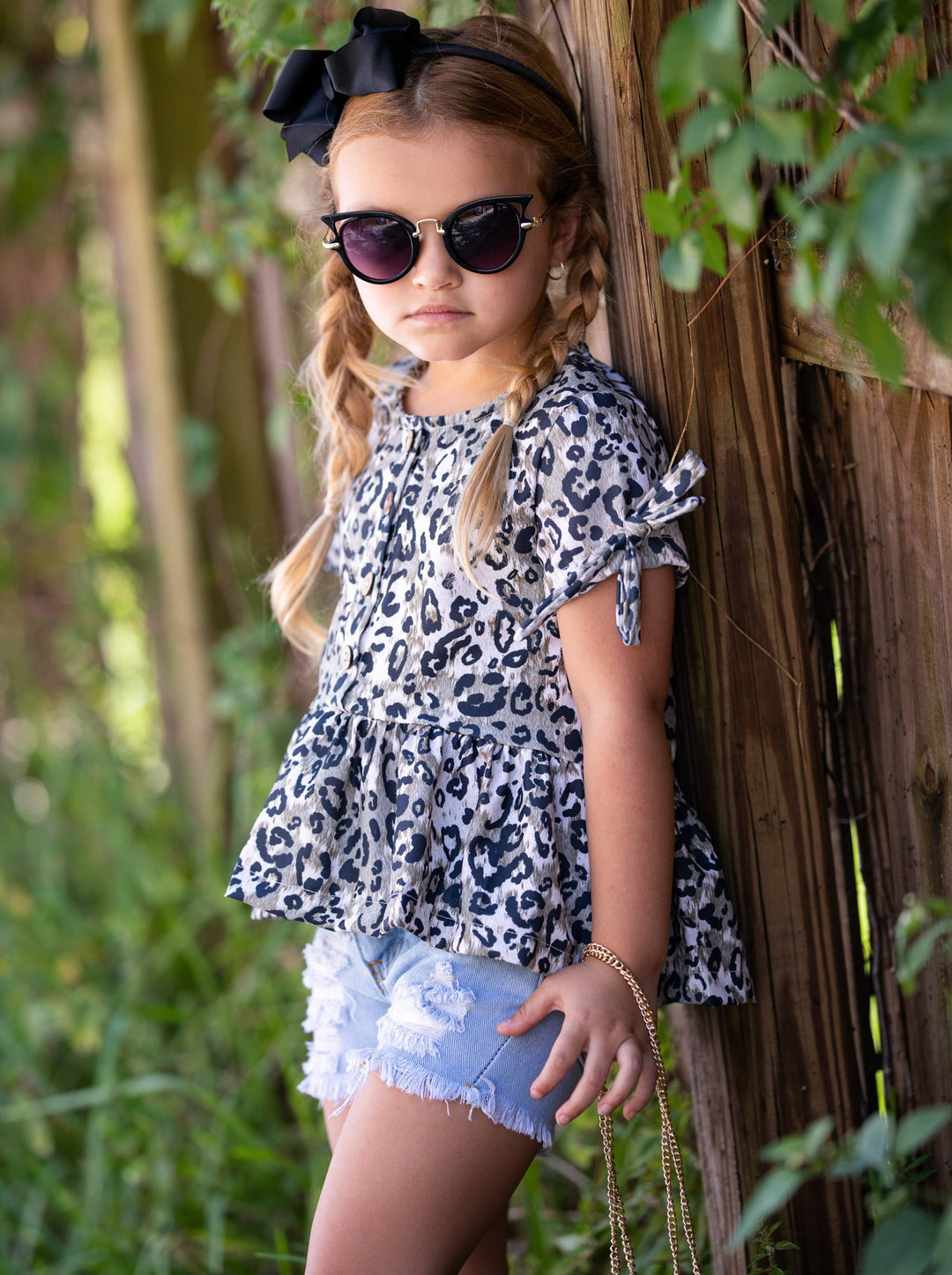 girls set features a leopard printed top with distressed denim shorts