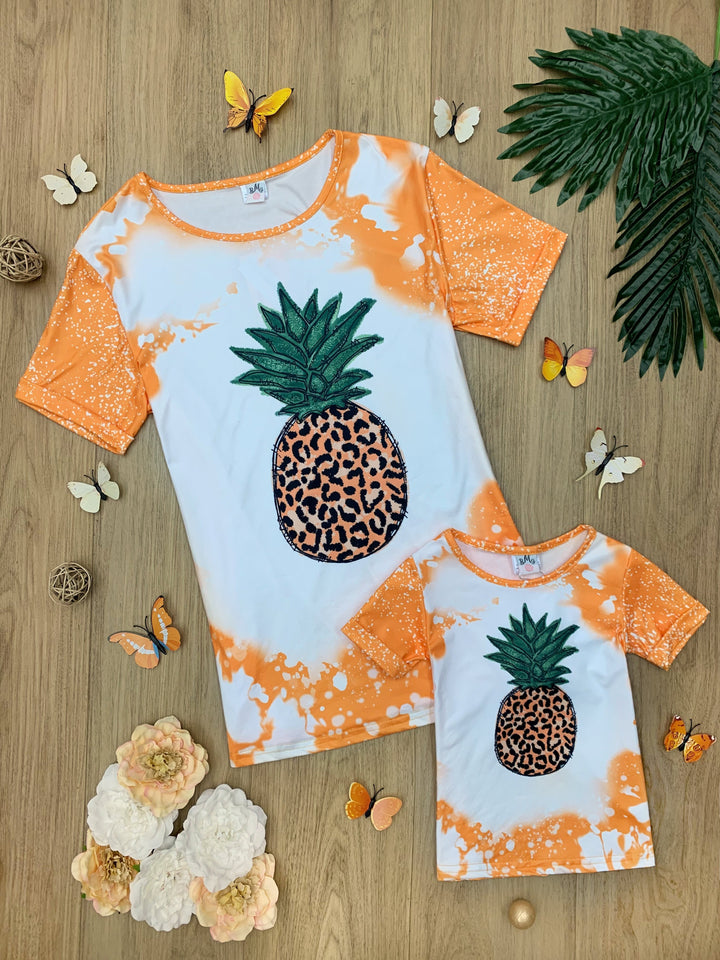 Mother-daughter top features tie-dye sleeves, back, and hem with a leopard print pineapple graphic design - 12MON-8Y for toddlers and girls and S to XL for Moms