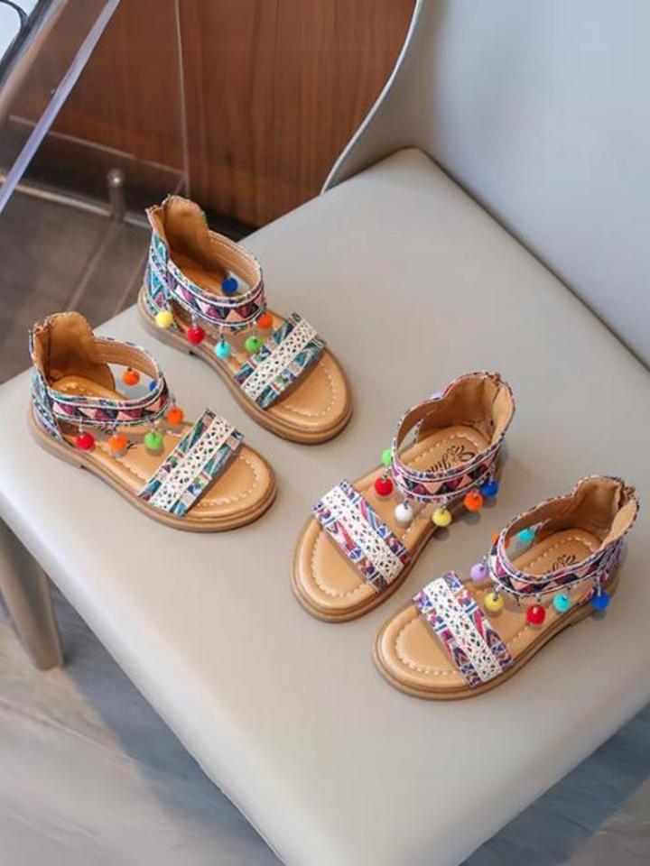 Mädchensandalen mit Boho-Tribal-Print und Pompons von Liv und Mia