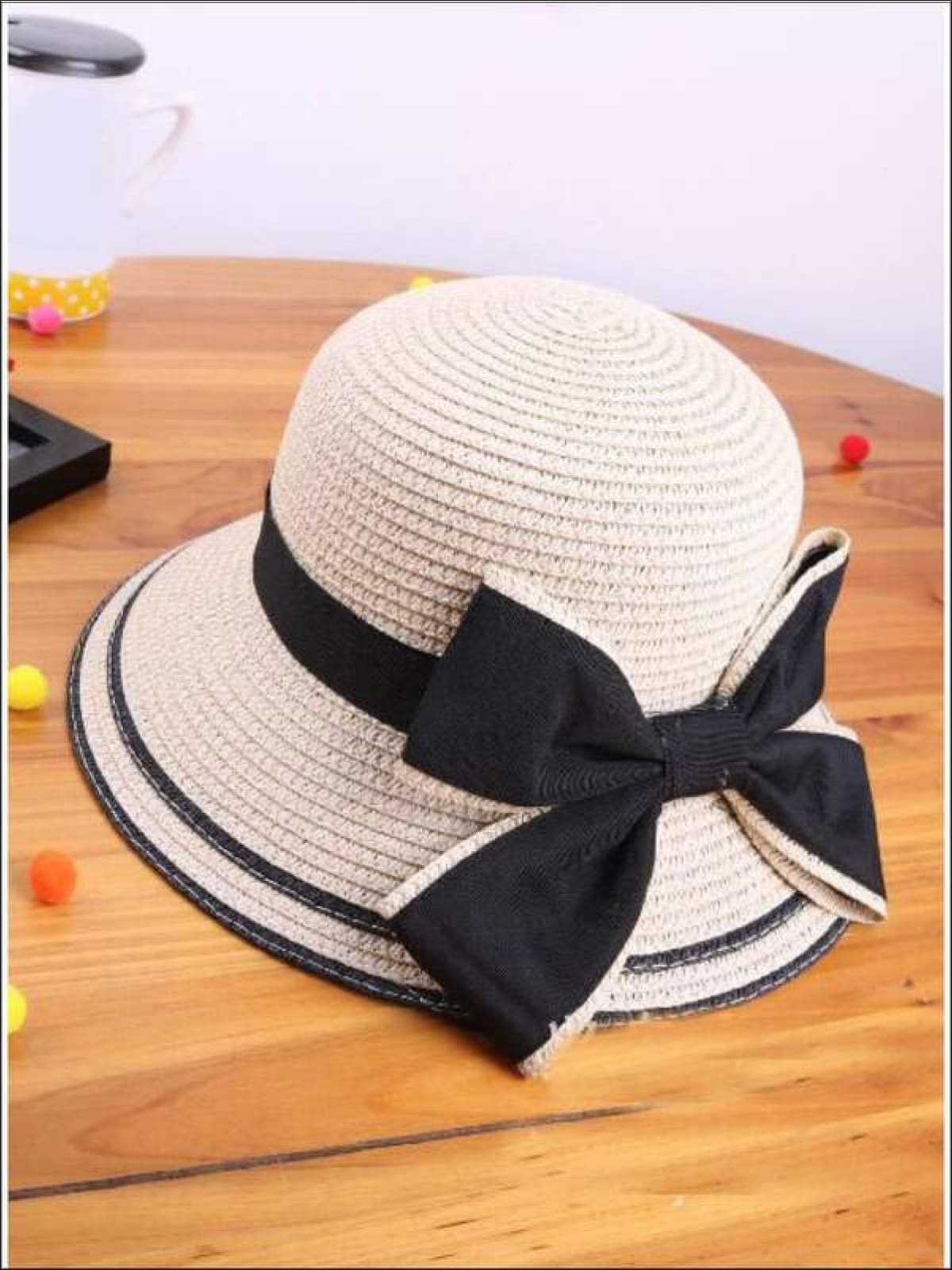 White floppy hat with black bow sales